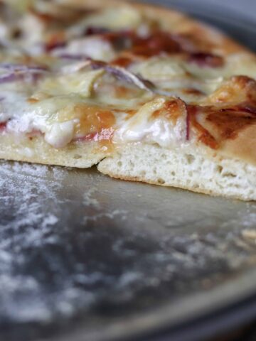showing a baked pizza crust with a slice missing