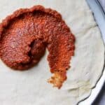 pizza sauce glob swirled on pizza crust