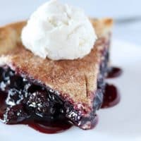 slice of cherry rum pie with vanilla bean ice cream on top