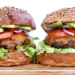 two burgers standing tall side by side