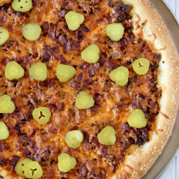 cheeseburger pizza baked and topped with pickles