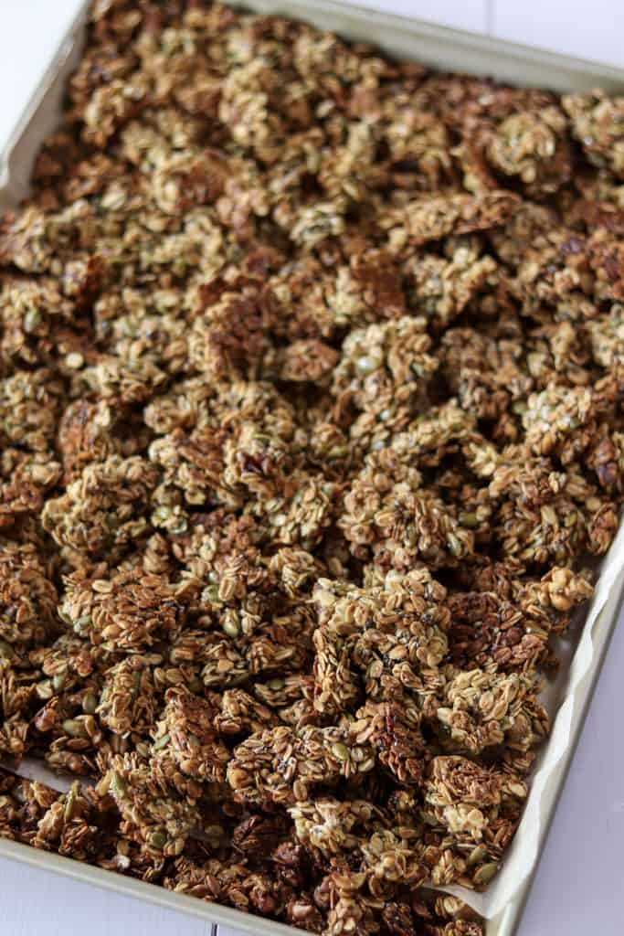 sheet pan of broken granola clusters after baking