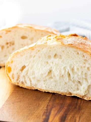 a completed loaf of no knead bread cut in half
