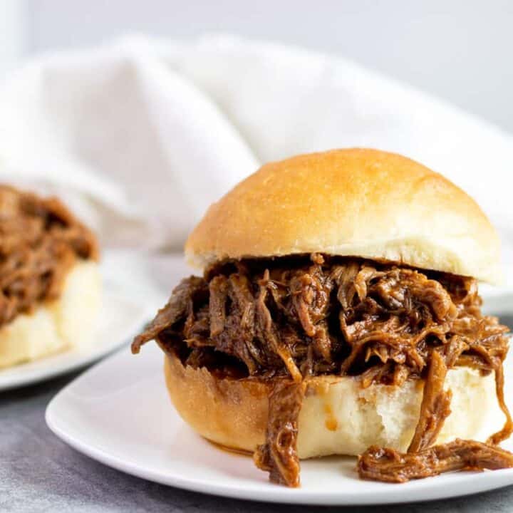 two Slow Cooker BBQ Pulled Pork sandwiches, ready to be served