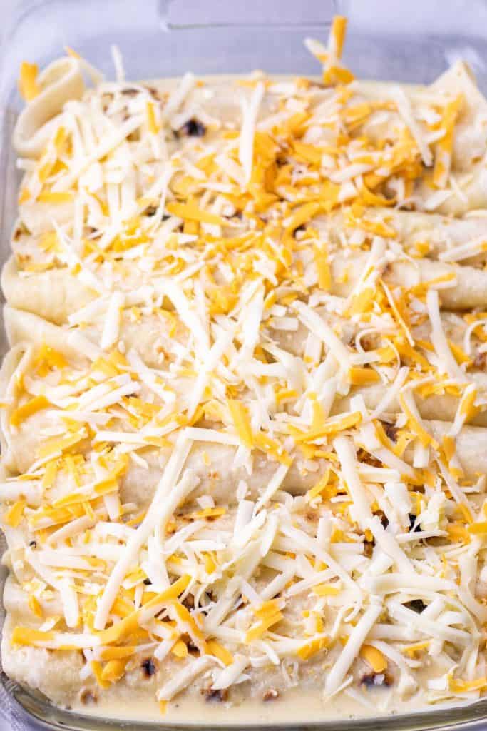 topping the breakfast enchiladas with the remaining cheese