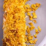 a portion of 2 breakfast enchiladas placed on a grey plate, ready to be served.