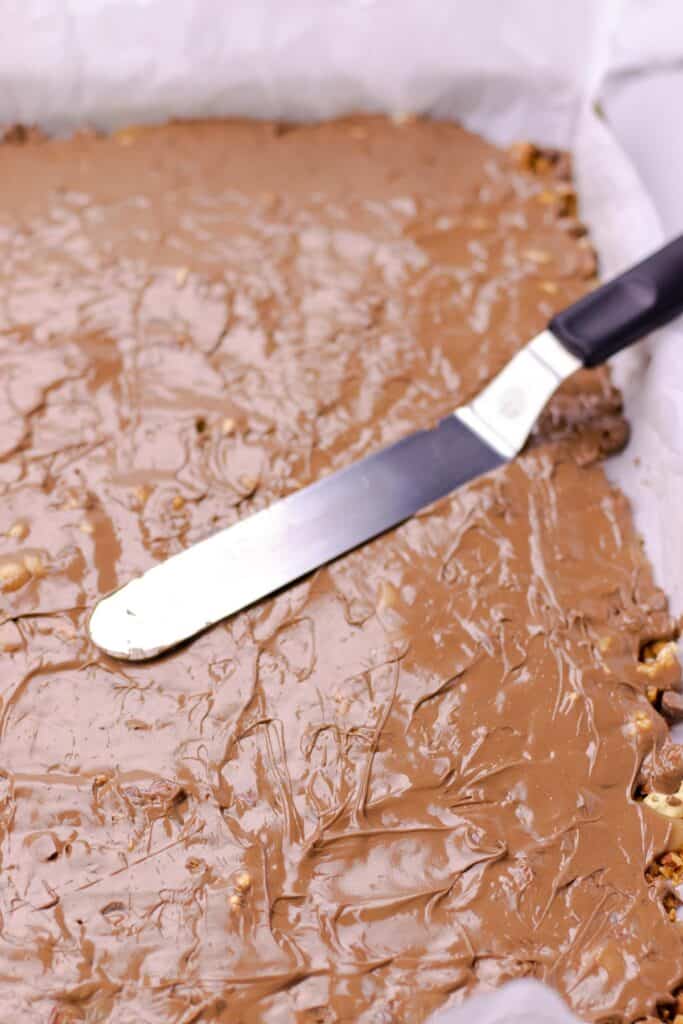 using an offset spatula to spread out the chocolate after it melts