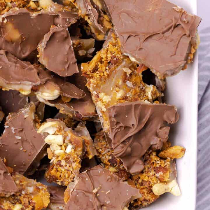 a serving bowl full of Almond & Cashew Buttercrunch Toffee