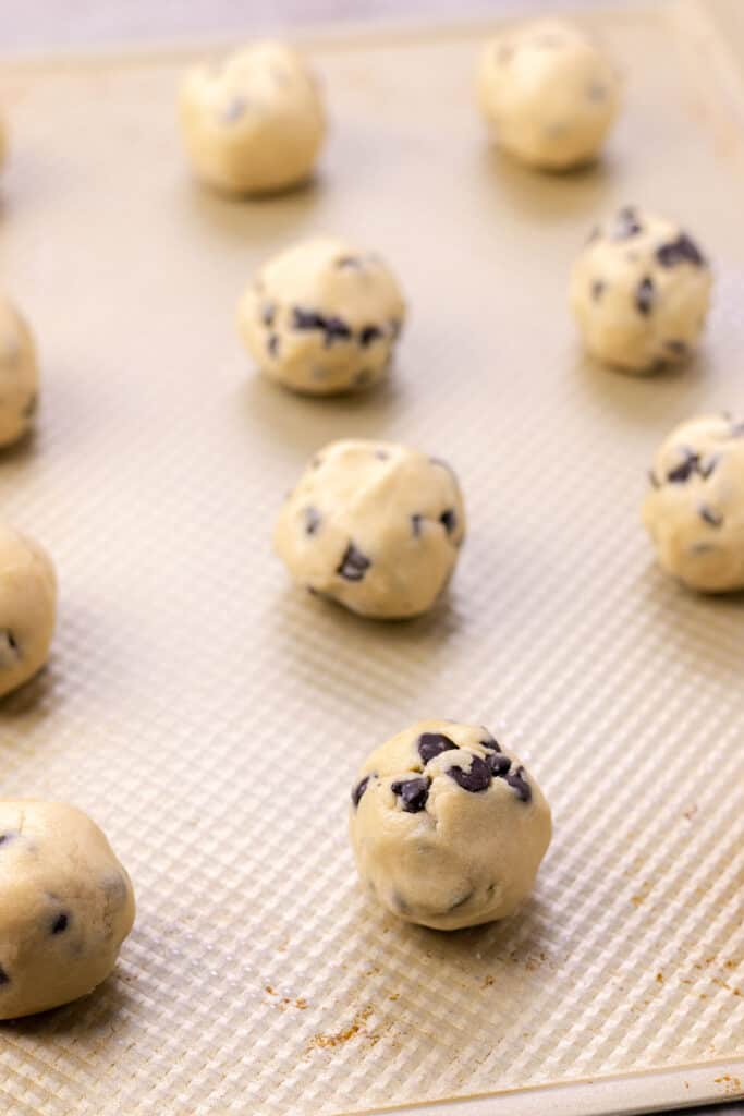 the chocolate chip cookies after they have been rolled into smooth balls