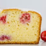 The inside of the raspberry lemon loaf showing a perfect golden crumb.