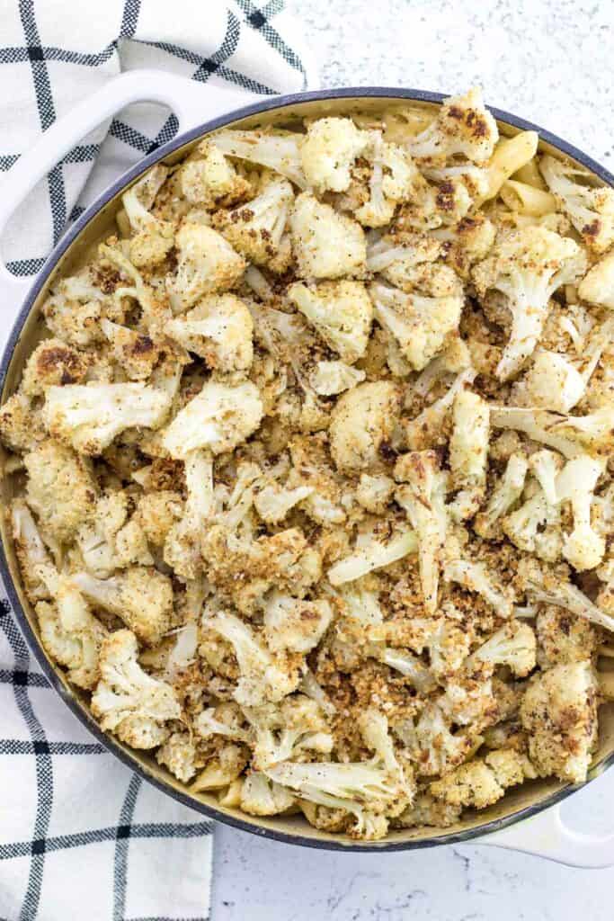 topping the mac and cheese with a batch of oven roasted cauliflower