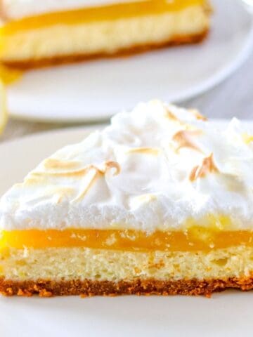 a single slice of lemon meringue cheesecake on a white plate