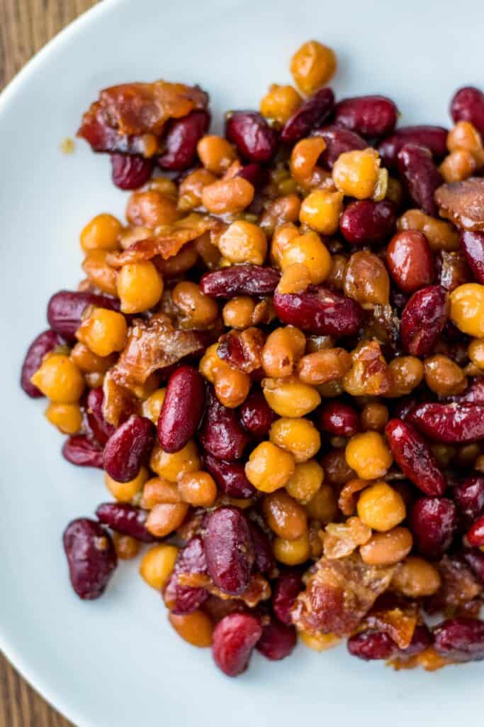 a serving of beans on a white plate