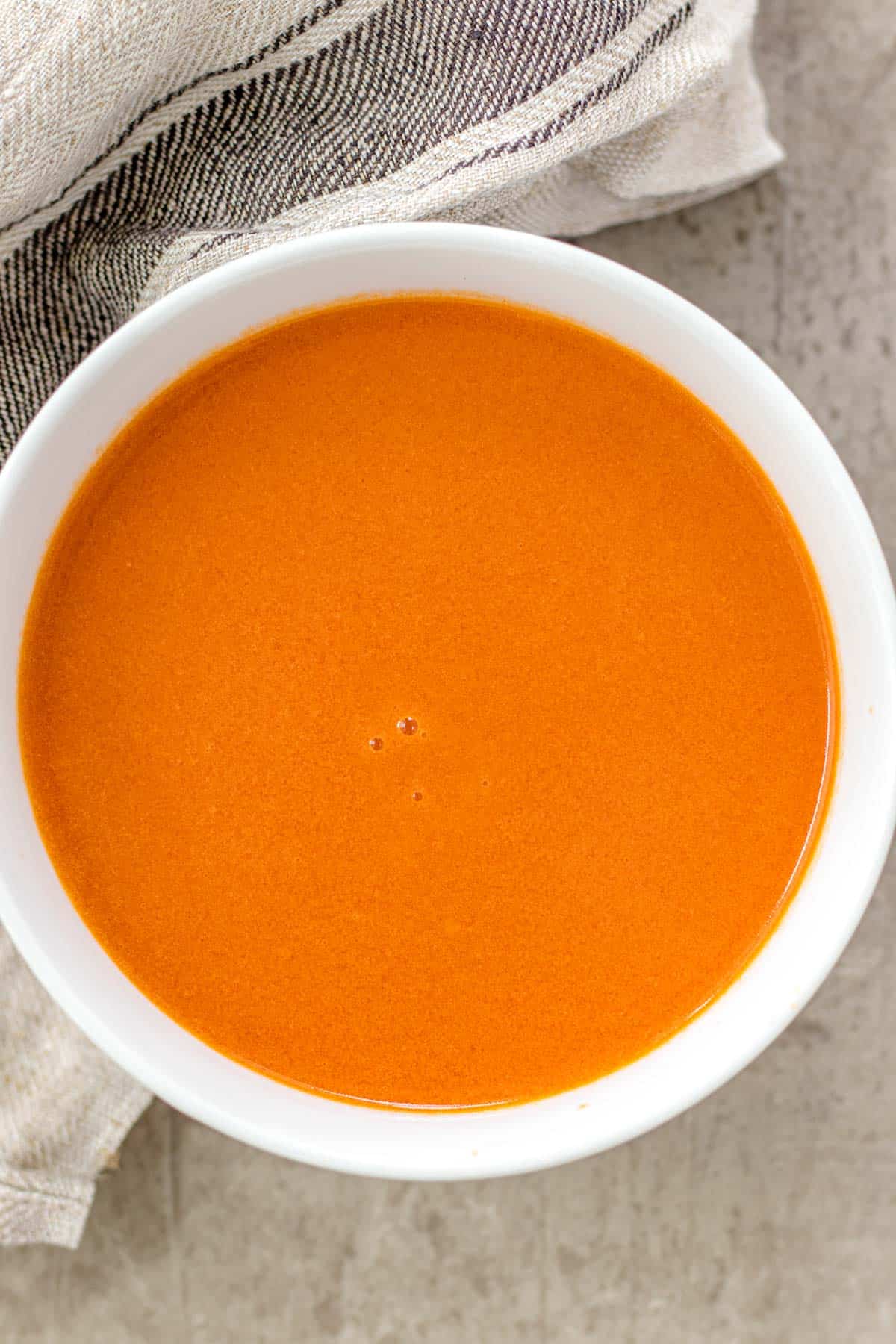 buffalo sauce in a white serving bowl
