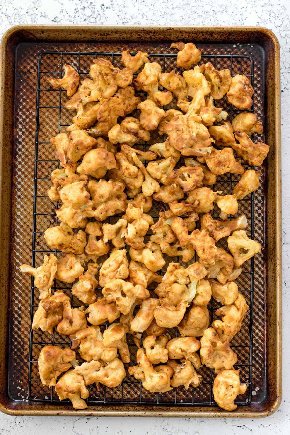 cauliflower wings after they have been air fried on a cooling rack