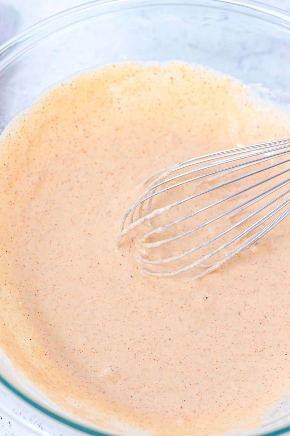 whisking the batter in a mixing bowl