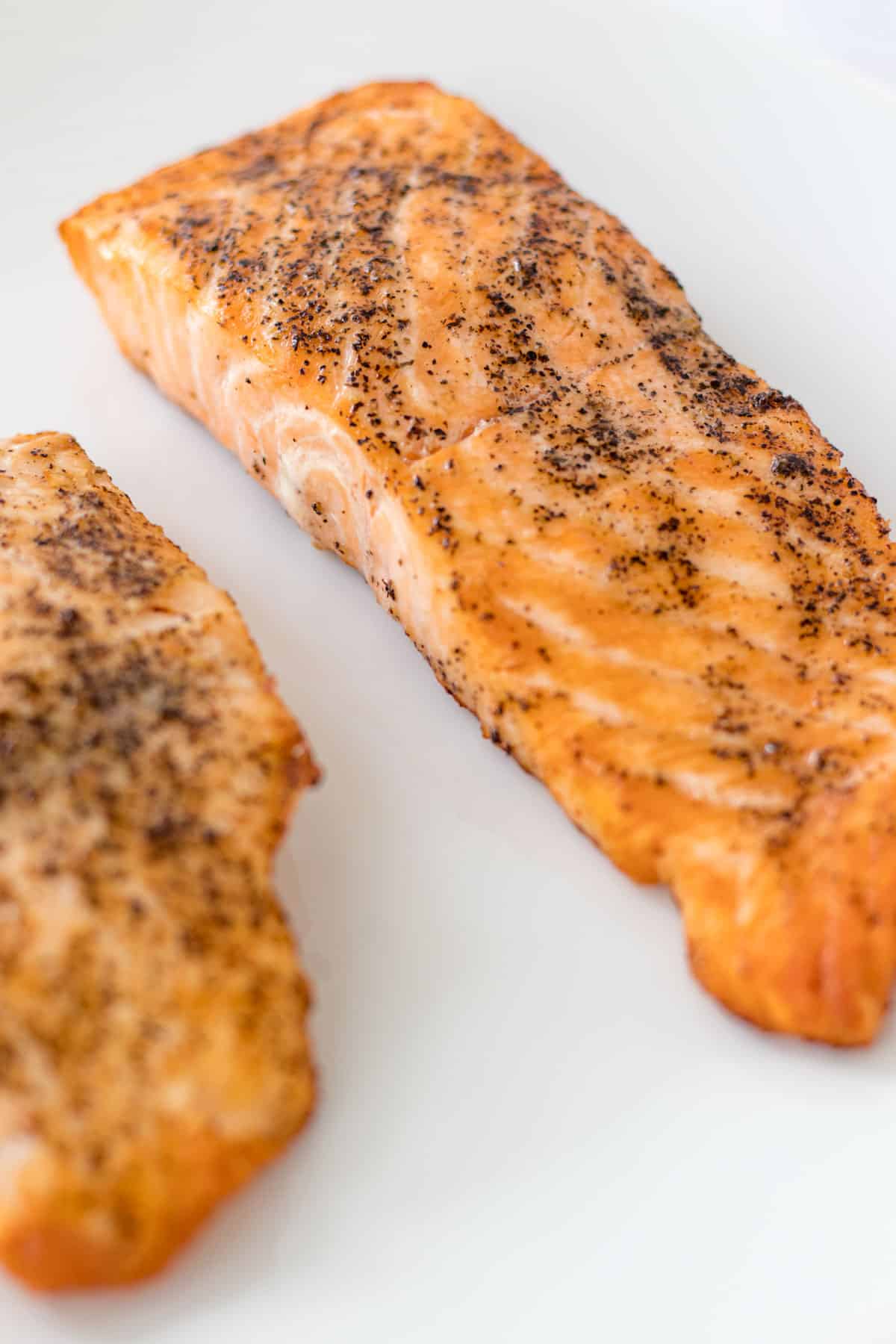 salmon filets close up after they have been cooked showing the crispy edges