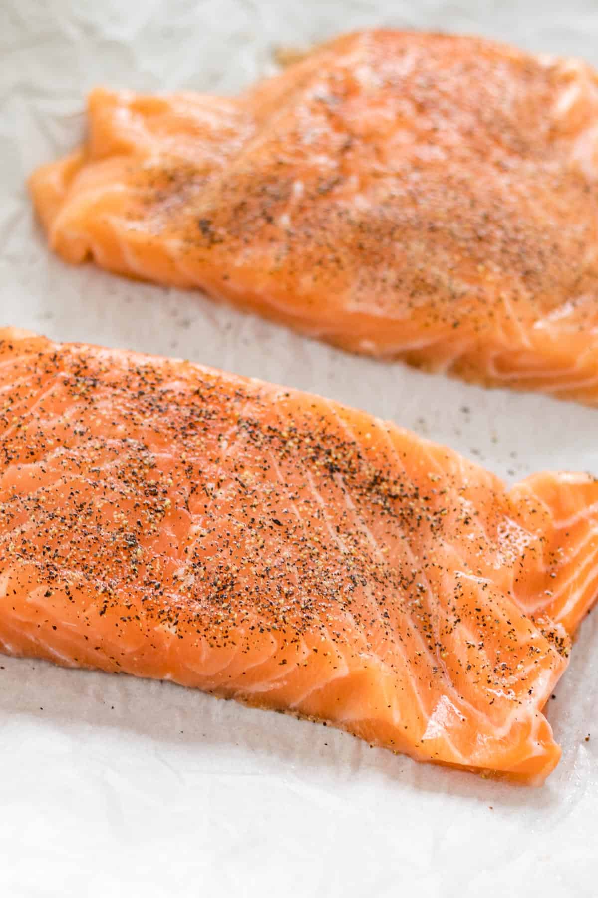 raw salmon filets after the ingredients have been added