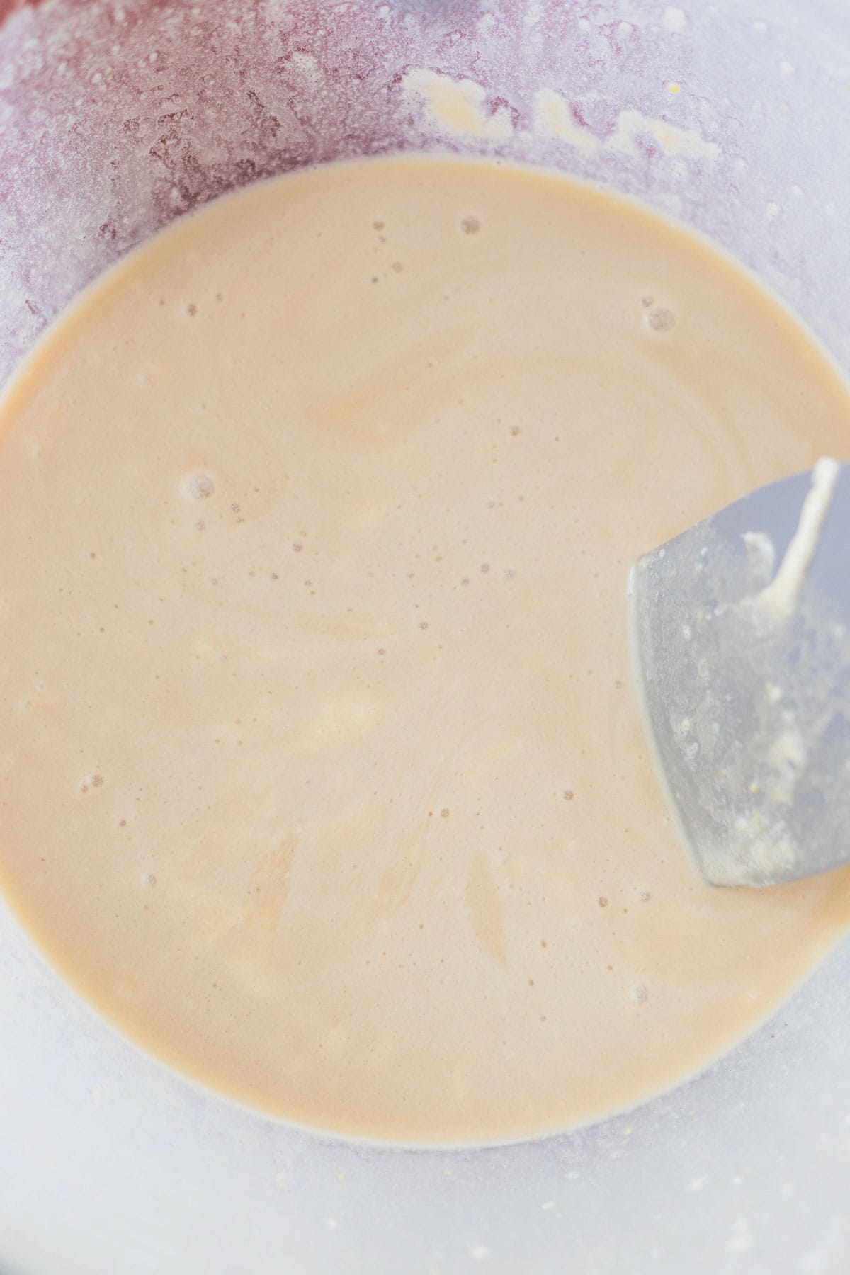 The wet ingredients for the cake batter in a mixing bowl.