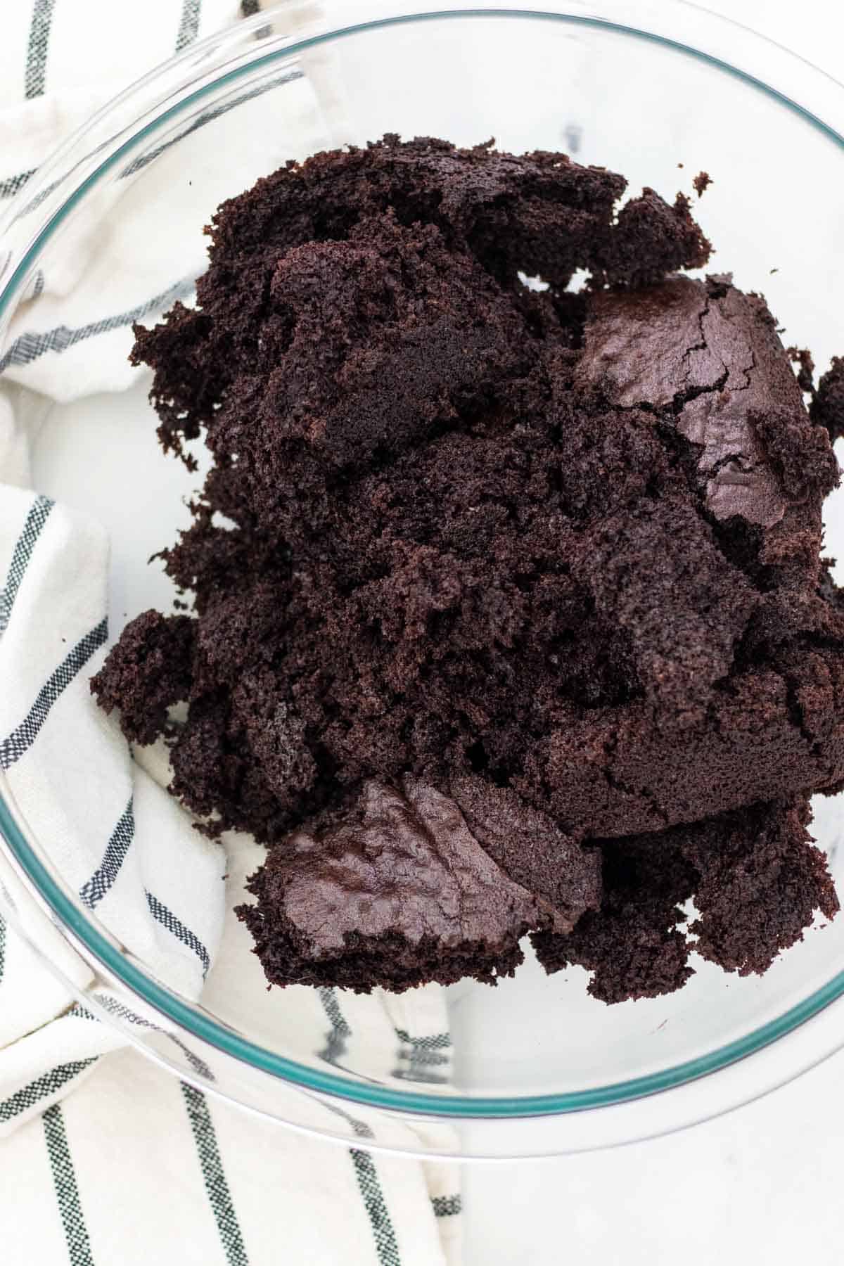 Chocolate cake crumbled in a large mixing bowl.