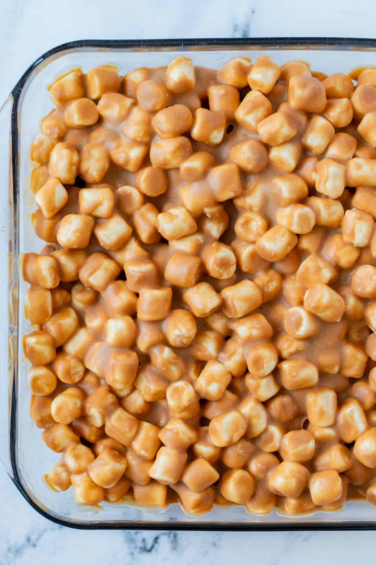 Peanut butter marshmallow squares in the baking dish after they have set in the refrigerator.