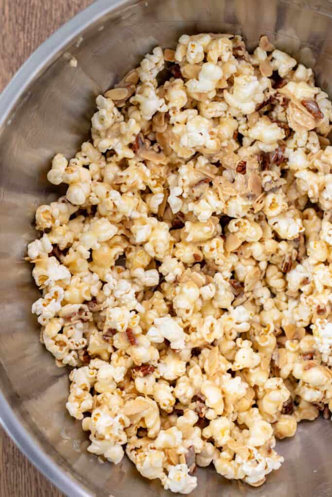 Tossing the popcorn with the caramel sauce.