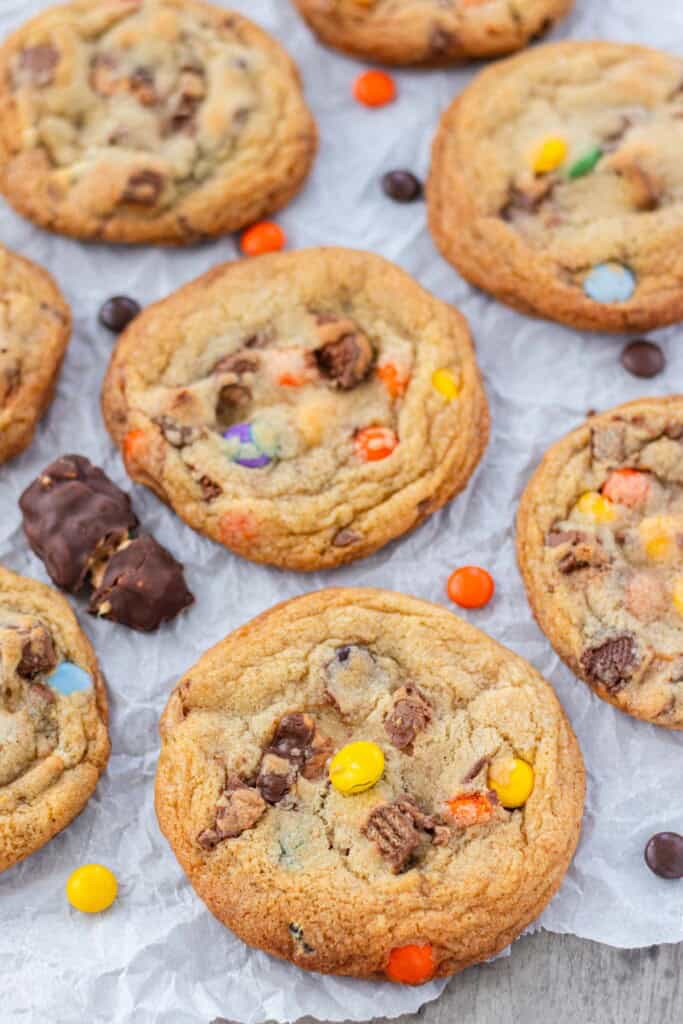 A close up of a cookie loaded with halloween candy.