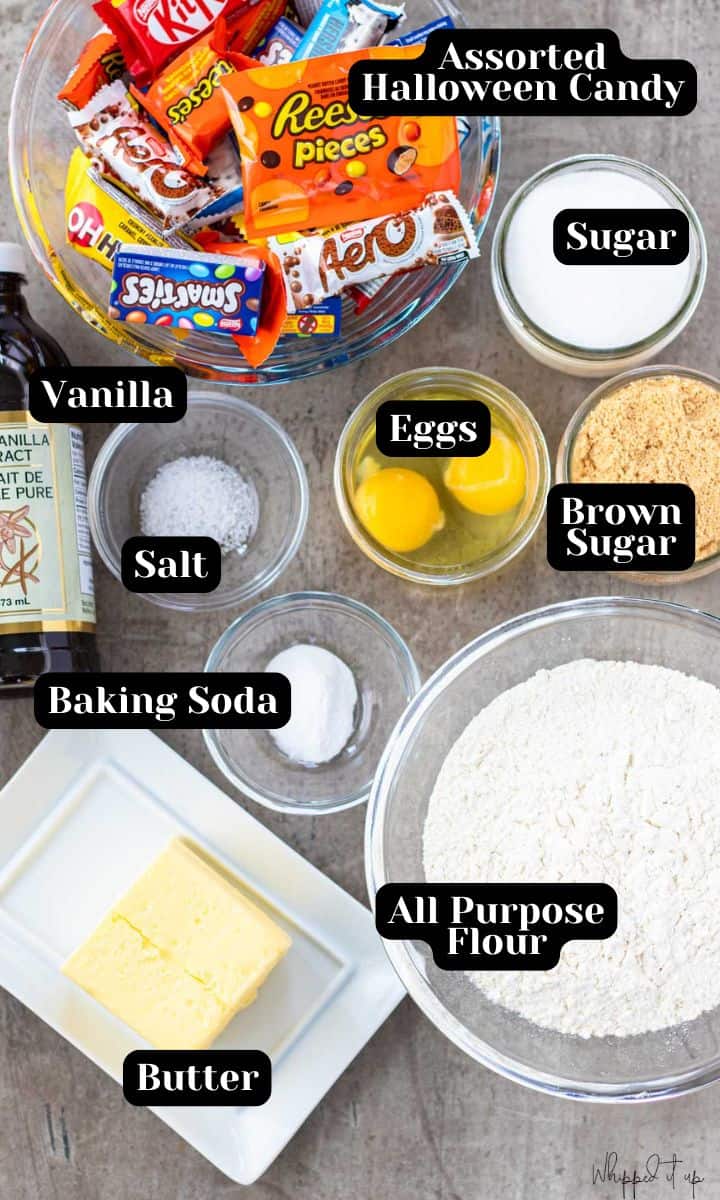 Ingredients to make these cookies include; assorted halloween candy bars, sugar, brown sugar, eggs, salt, vanilla, baking soda, all purpose flour and butter.