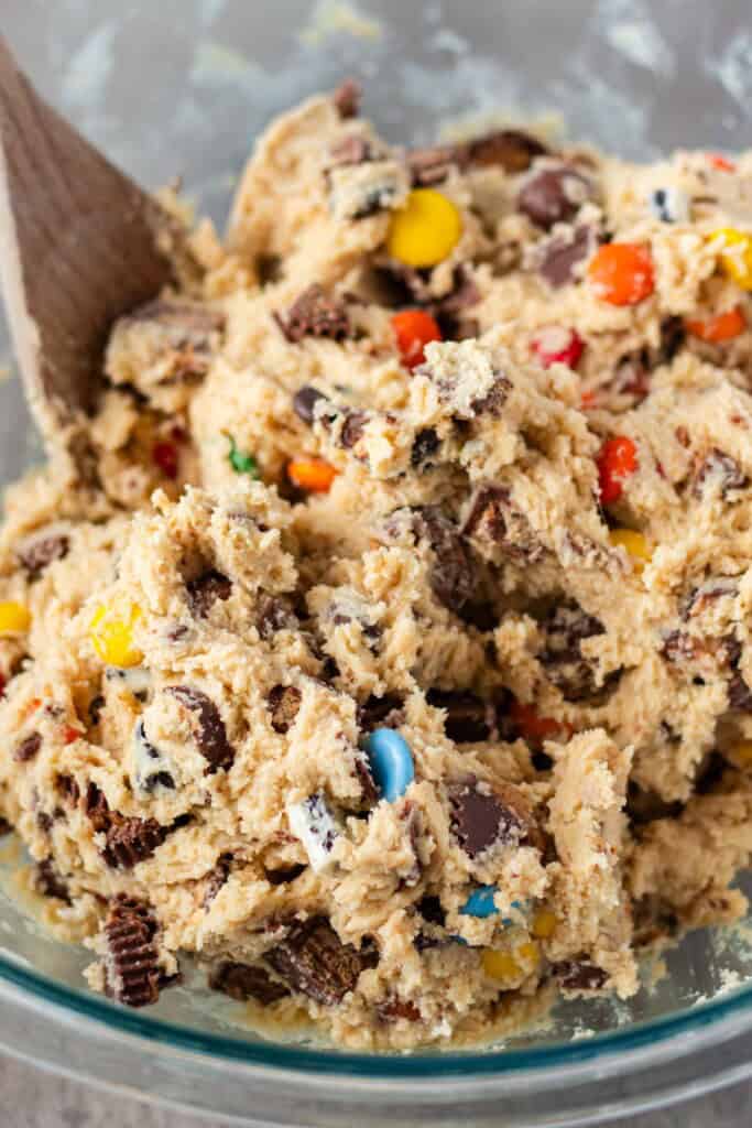 Stirring the chopped candy bars into the cookie dough.