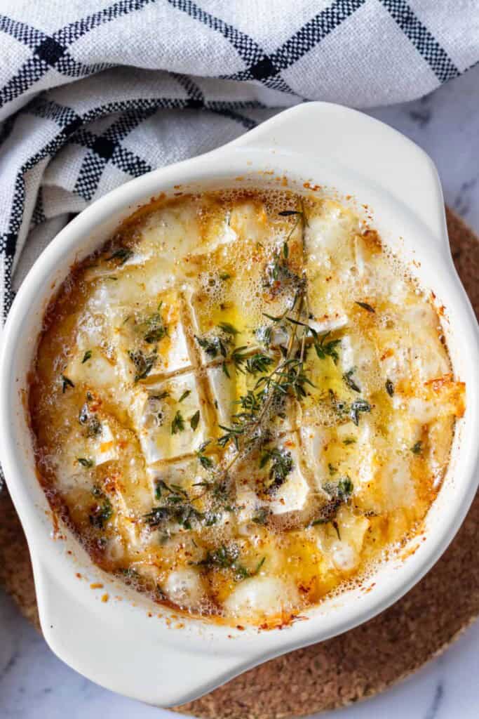 Camembert Roti baked in a brie baker on a cork coaster.