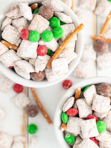 Christmas puppy chow piled in white ramekins.