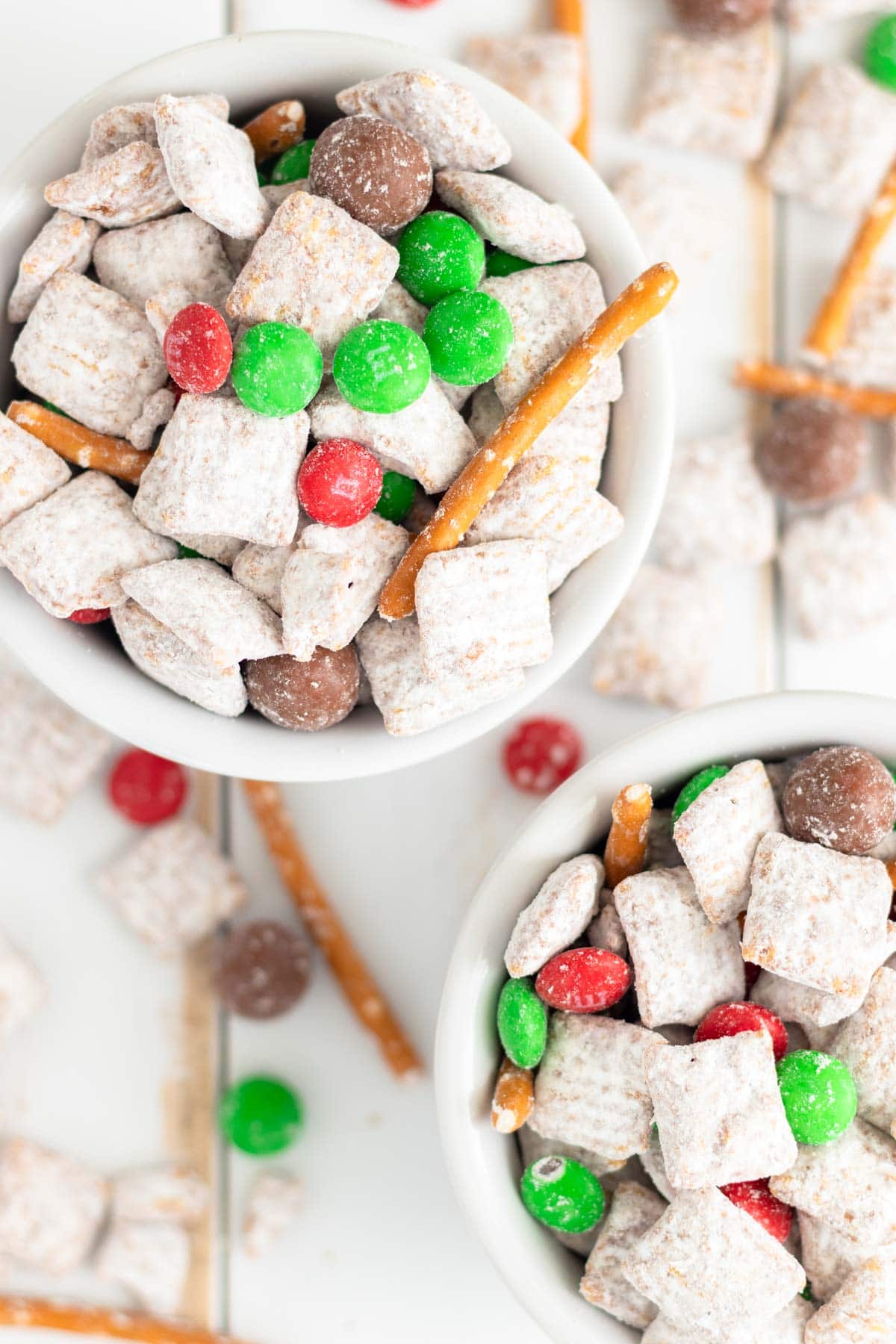 Christmas puppy chow piled in white ramekins.