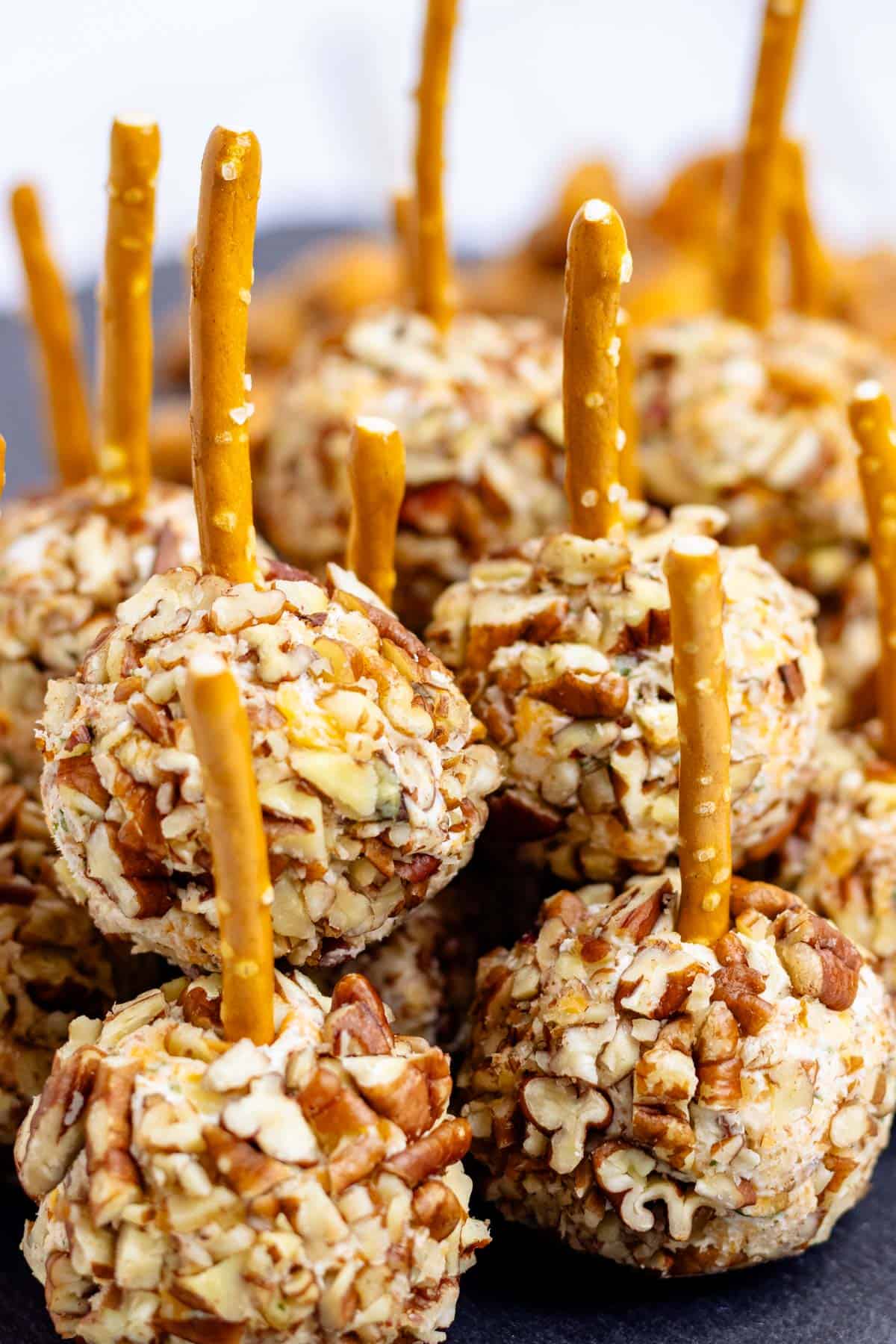 A pile of mini cheese ball bites on a serving tray.