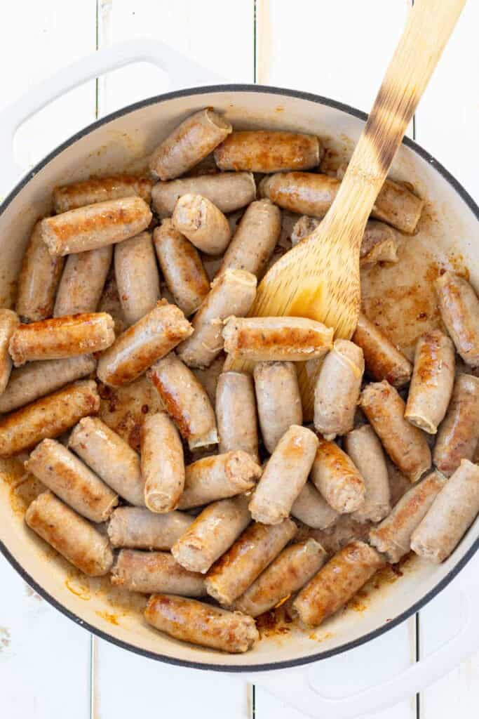 Browning the breakfast sausages in an enamelled cast iron skillet.