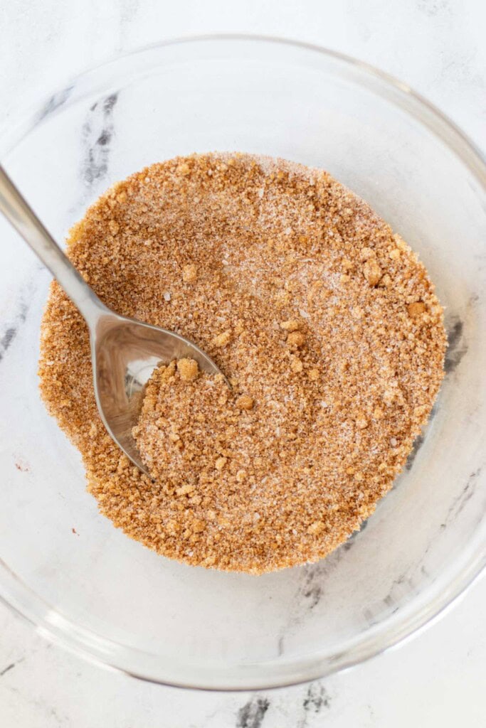 Mixing the cinnamon sugar in a glass bowl.