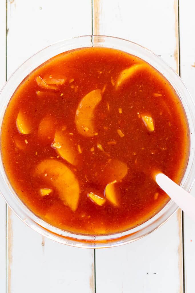 All ingredients to make sweet and sour sauce mixed together in a bowl.