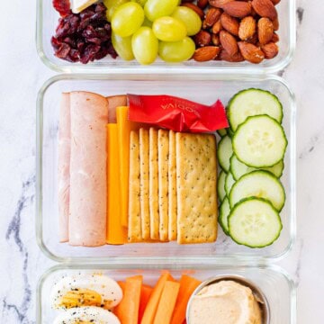 Three adult lunchable options in a row. Ham and cheese, brie and almond and, egg and apple.