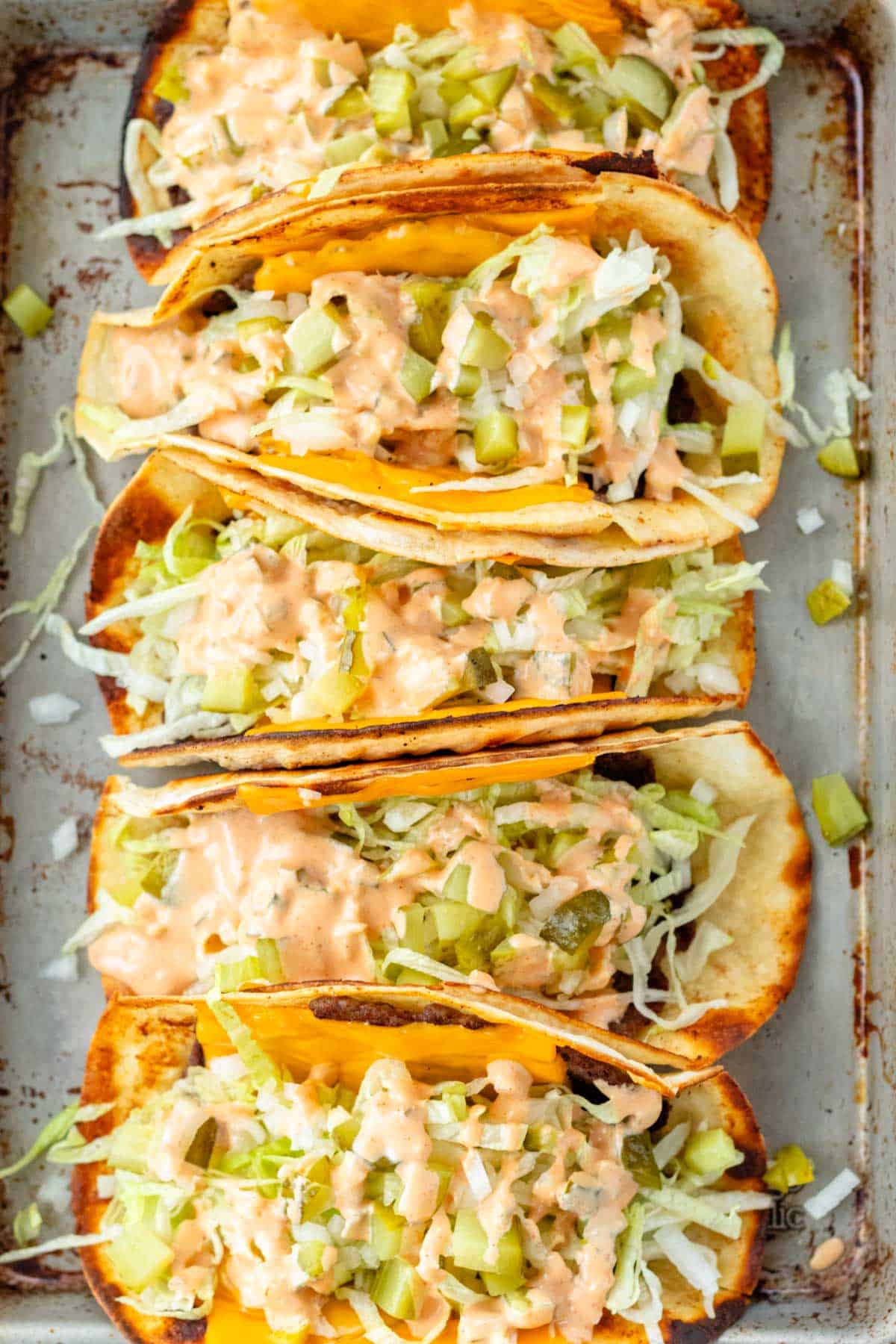 Big mac smash tacos lined up on a serving tray.