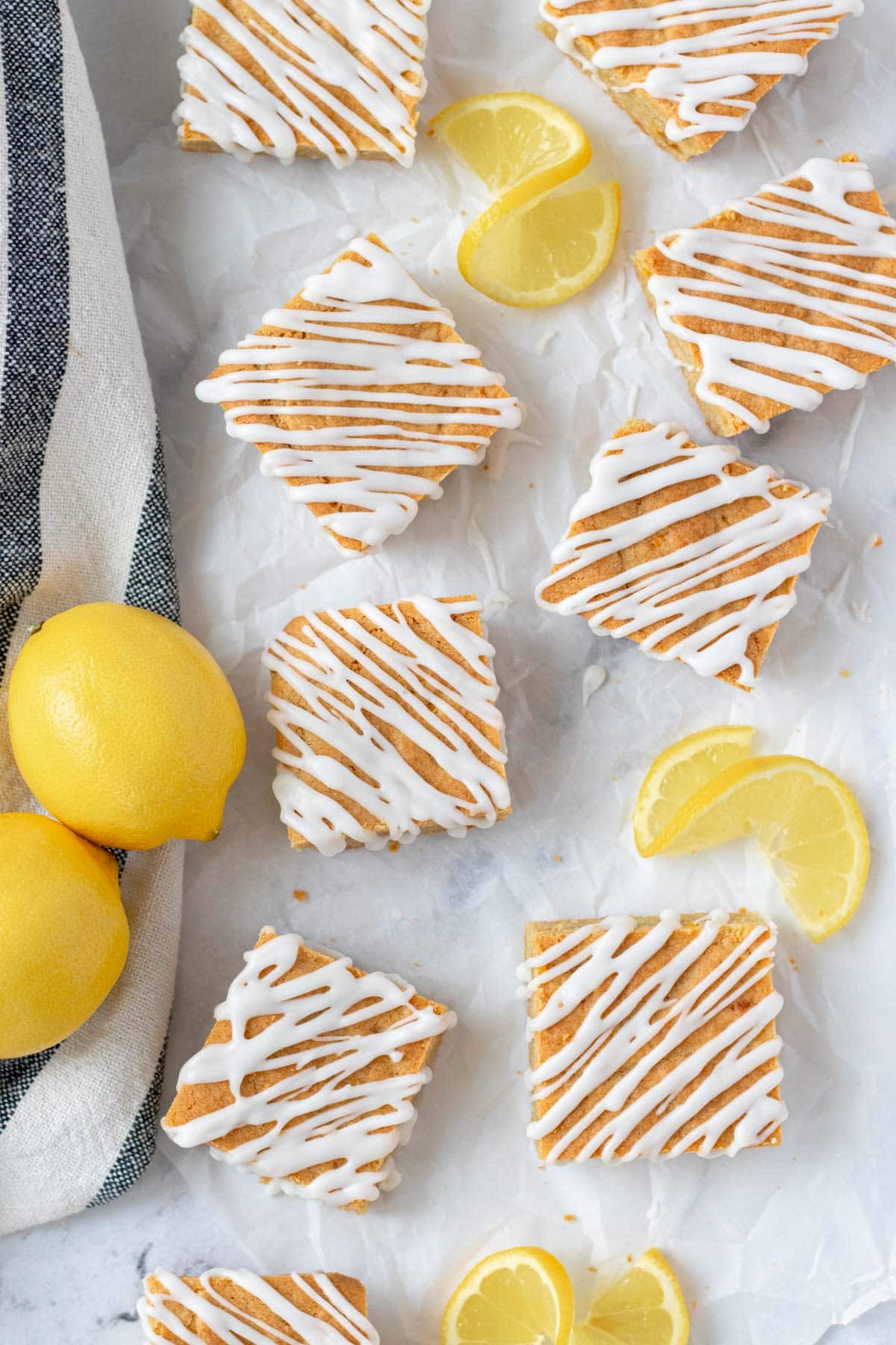 Lemon blondies laid out on a piece of parchment paper.