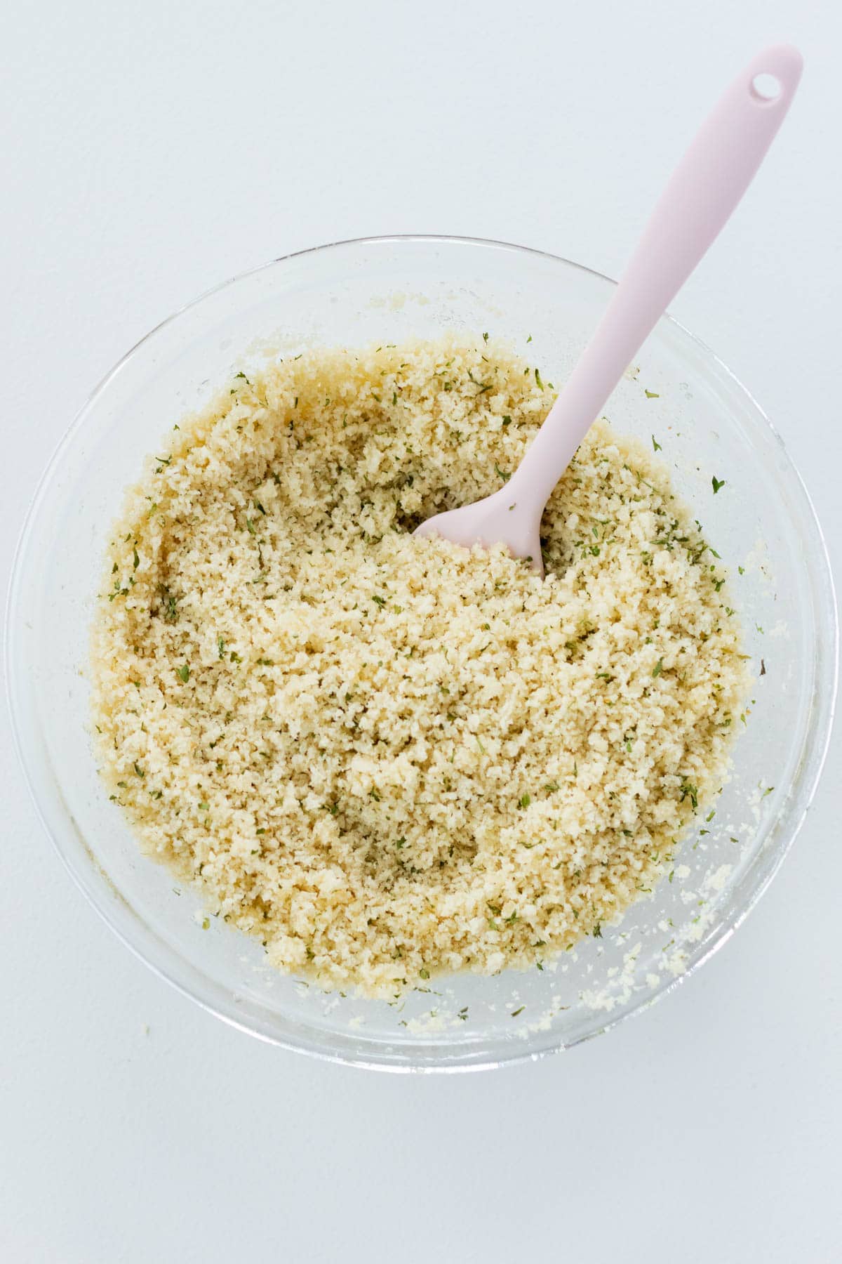 Mixing the panko breadcrumbs with butter and parsley for the topping.