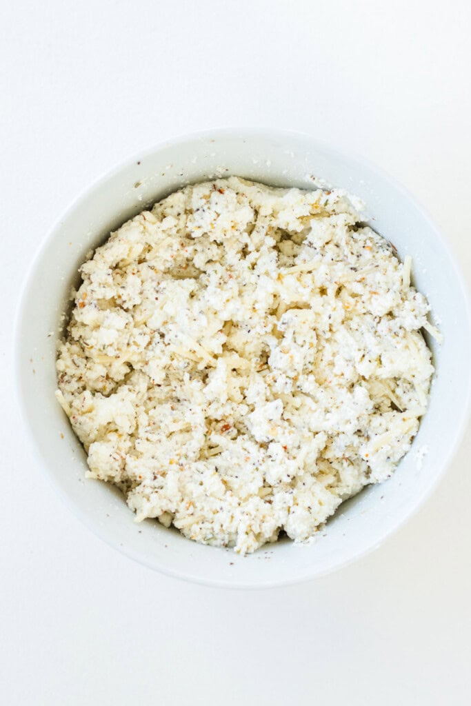 A bowl filled with spiced ricotta cheese topping.