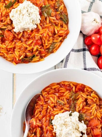 Two while bowls filled with lasagna soup made in a slow cooker.