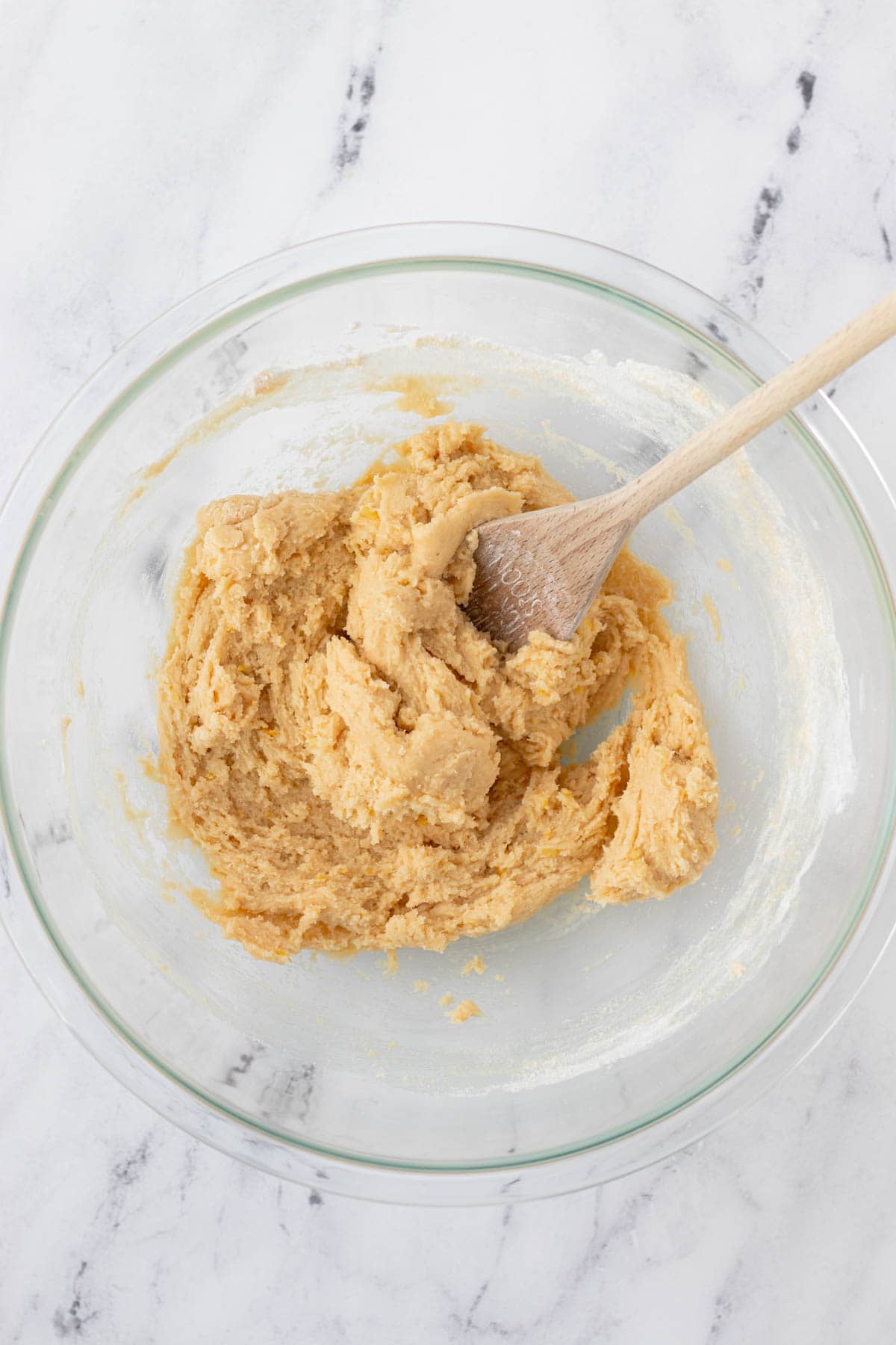 Stirring in the dry ingredients to make a thick batter.