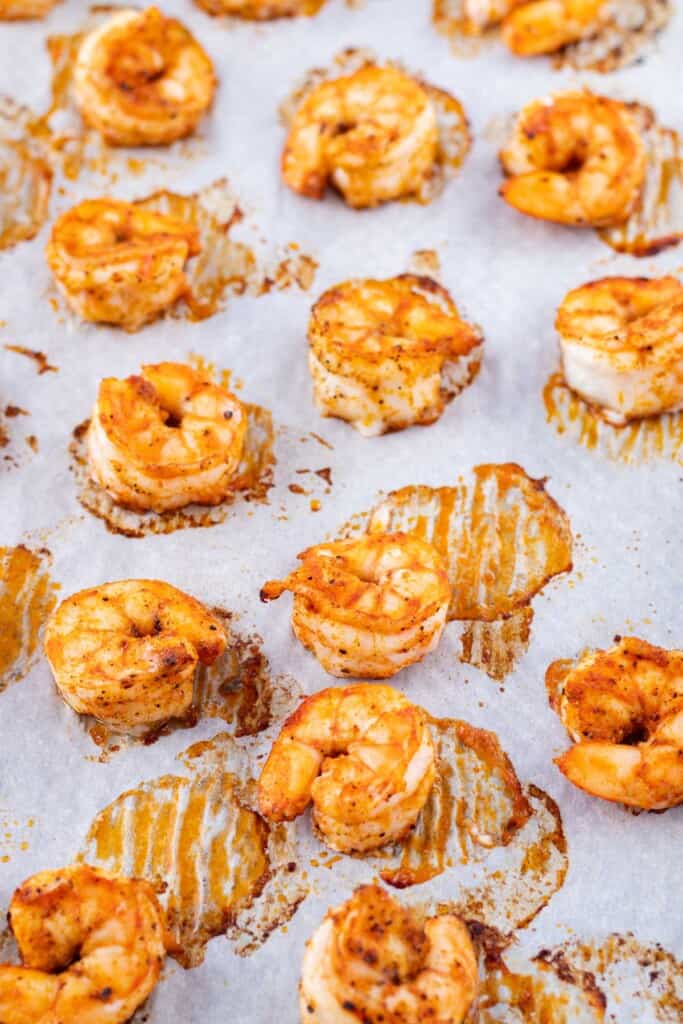 Baked shrimp on a baking sheet.