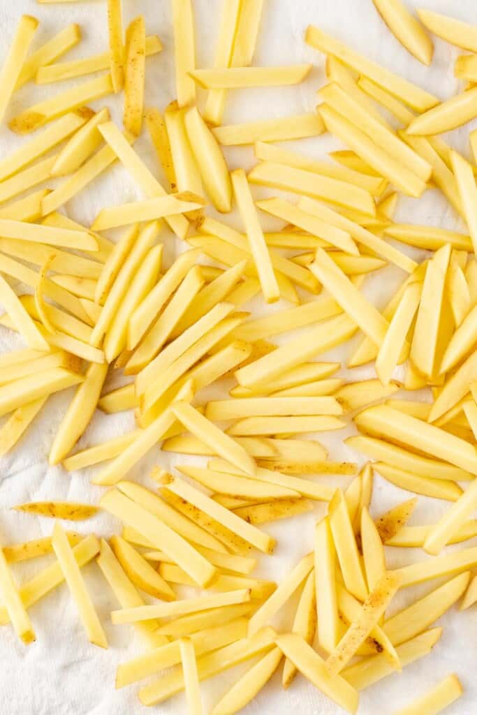 Drying the fries between paper towels.