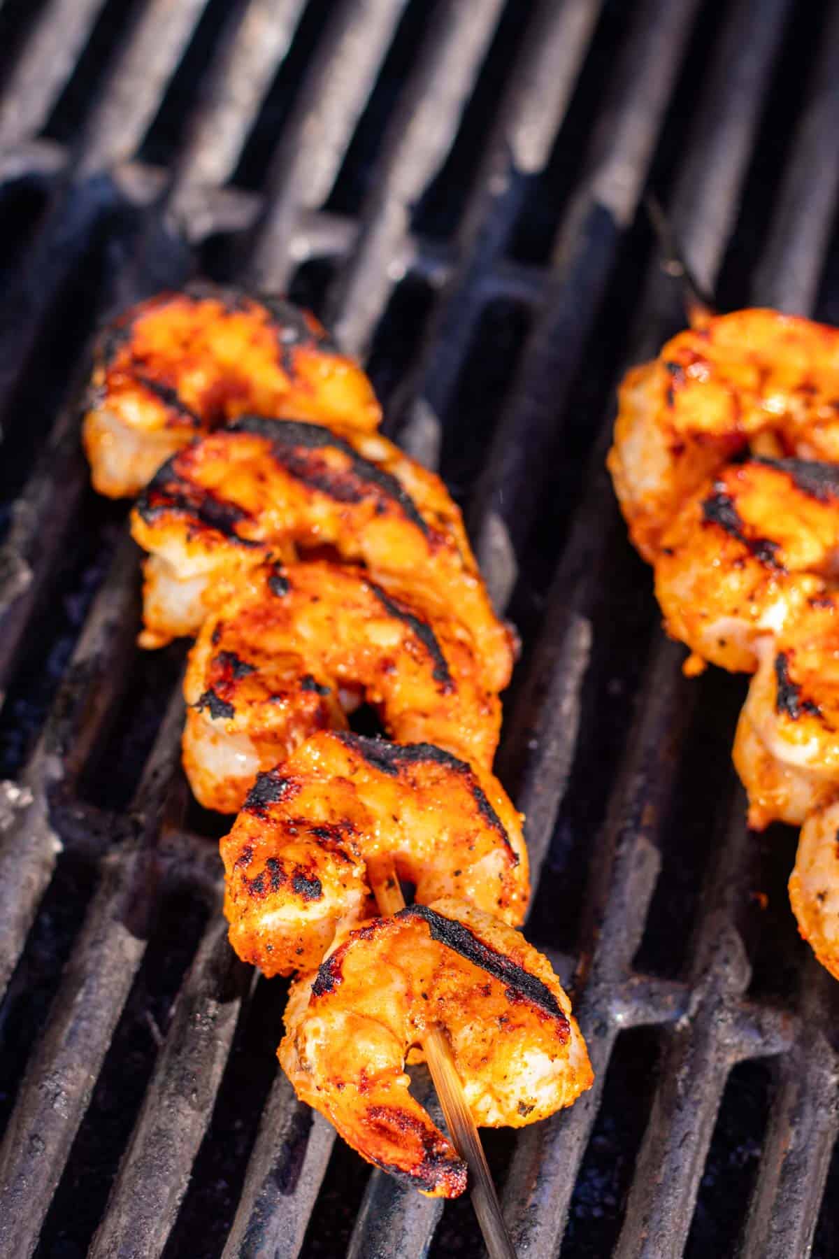 Grilling the shrimp skewers on the barbecue.