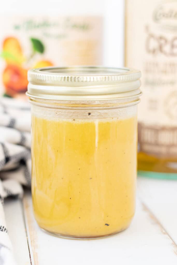 The salad dressing in a mason jar after being shaken.