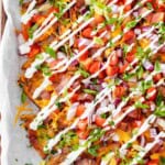 Loaded french fries piled high with topping like tomatoes, red onions, bacon and cheese, finished with a sour cream drizzle.