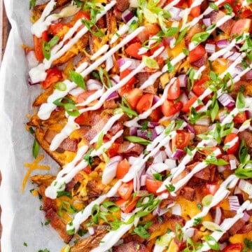 Loaded french fries piled high with topping like tomatoes, red onions, bacon and cheese, finished with a sour cream drizzle.