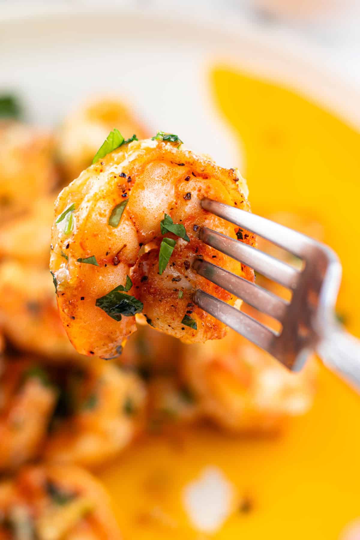 A single shrimp speared on a fork.